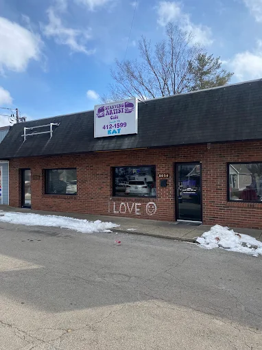 Exterior of Starving Artists Cafe & Deli with its sign on New La Grange Rd